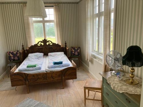 a bedroom with a bed in a room with windows at STF Tre Björnar B&B in Älvdalen