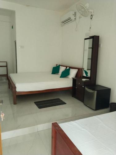a bedroom with a bed and a mirror in a room at Yala Villa Harmony in Debarawewa