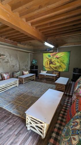 a room with couches and a painting on the wall at MudHouse Retreat, Sarajara in Bīr