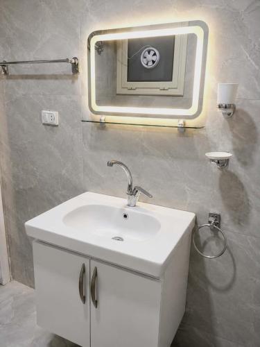 a bathroom with a sink and a mirror on the wall at Lavanda Beach Resort in Abū Rudays