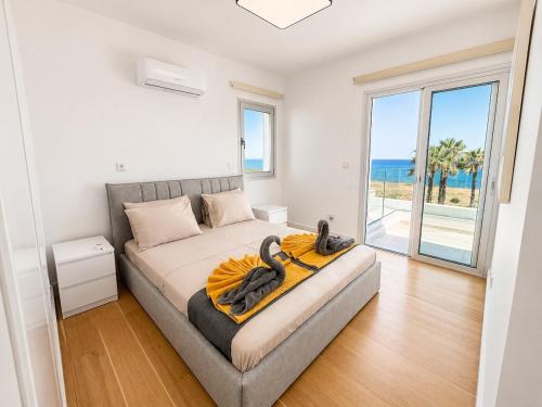 a bedroom with a bed with a view of the ocean at Villa Celestia in Neo Chorio