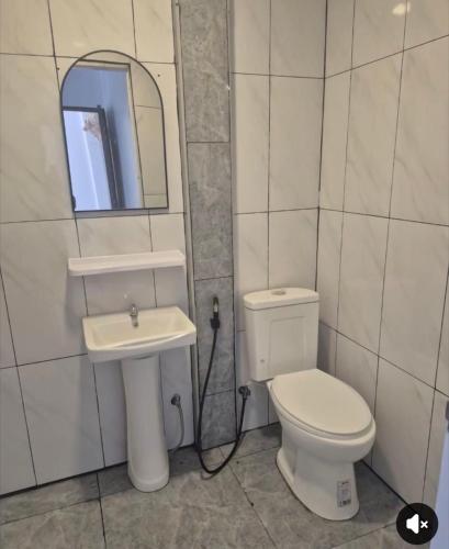a bathroom with a toilet and a sink and a mirror at SET Inn-2 in Kata Beach