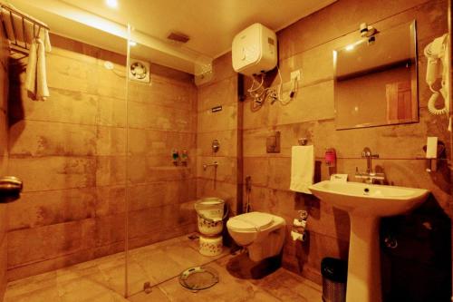 a bathroom with a toilet and a sink at Kali Tibba Resort Chail in Chail