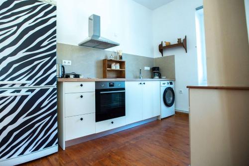a kitchen with a stove and a dishwasher at Casa Sulla Montagna North Corfu in Loútsai