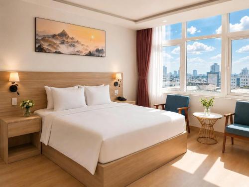a hotel room with a bed and two chairs at G8 Center Hotel Saigon in Ho Chi Minh City