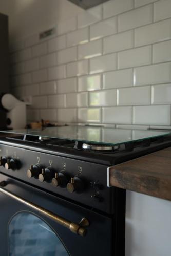 a black stove top oven in a kitchen at Bellevall resort, hotel y apartamentos in Aspe