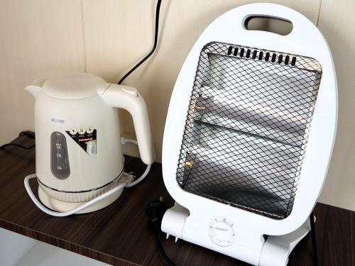 a coffee maker sitting on a counter next to a mixer at 1440 MDPL Villa & Resort in Wonosobo