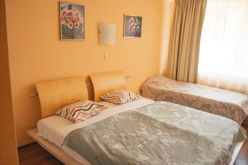 a small room with two beds and a window at Minhauzena Unda in Saulkrasti