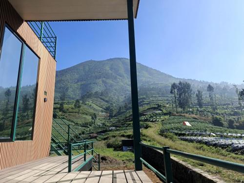 a building with a view of a mountain at 1440 MDPL Villa & Resort in Wonosobo