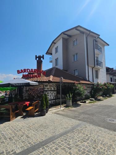 a building with a table in front of a building at Cтаи за гости Бърдареви in Bansko