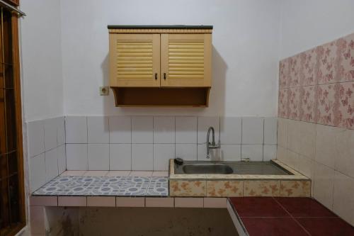 a kitchen with a sink and a counter top at The Kori Homestay in Munduk
