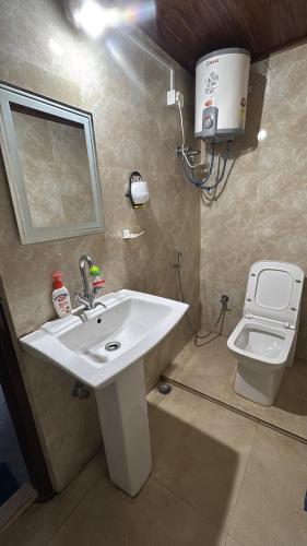 a bathroom with a sink and a toilet at Sungava homestay in Mirik