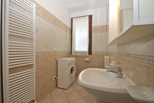 a bathroom with a sink and a washing machine at Smith 3B in Lido degli Estensi