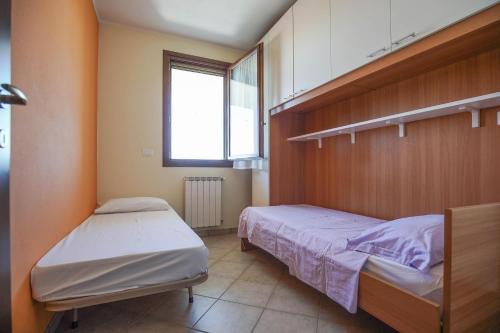 a bedroom with two beds and a window at Sul Mare Smith in Lido degli Estensi