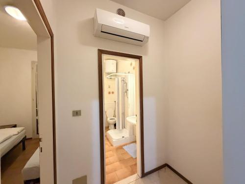 a bathroom with a toilet and a mirror at Villette Astoria in Lido degli Estensi