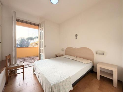 a bedroom with a large bed and a balcony at Villette Astoria in Lido degli Estensi
