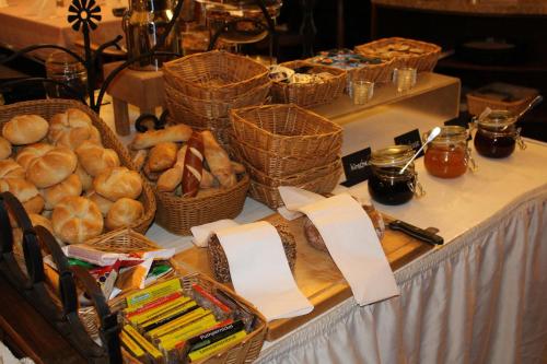 a table with baskets of bread and baskets of bread at Hotel Ulmer Spatz in Ulm