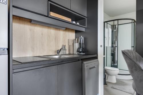 a bathroom with a sink and a toilet at Mobile Home Altura Luxury Sea View Retreat in Drage