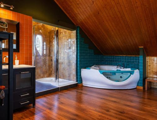 a large bathroom with a tub and a shower at Villa Aldán Areacova in Aldán
