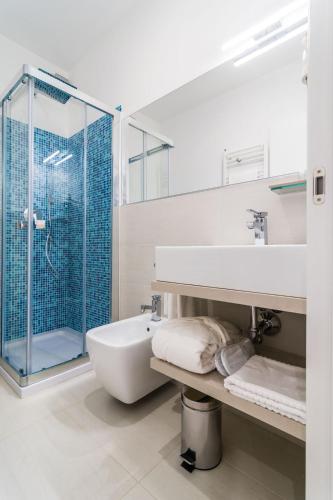 a bathroom with a tub and a sink and a shower at Deki Relais in Sassari
