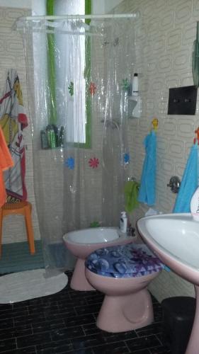 a bathroom with a shower and a toilet and a sink at Casa Roby 120 mt Beach in Fontane Bianche