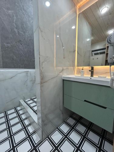 a bathroom with a sink and a shower at Zhaltyr resort in Astana
