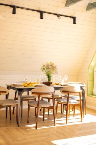 a dining room with wooden tables and chairs at Zhaltyr resort in Astana