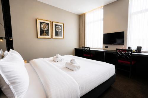 a hotel room with a bed with towels on it at Les Nuits in Antwerp