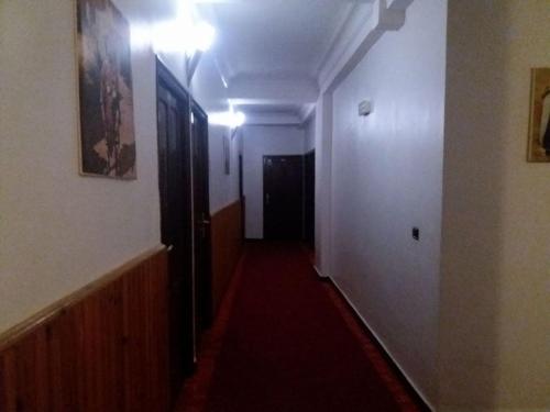 an empty hallway with a red carpet in a room at Hôtel Marina in Tetouan