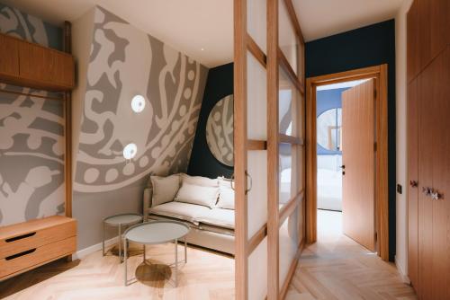 a room with a couch and a table at Meidan Heritage Suites Tbilisi in Tbilisi City