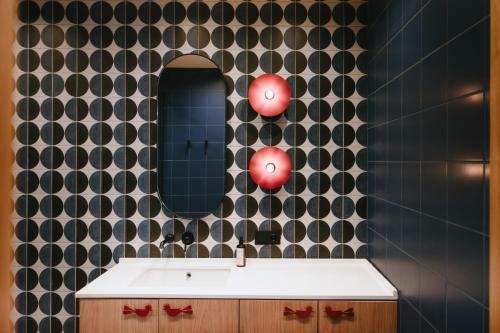 a bathroom with a sink and a mirror at Meidan Heritage Suites Tbilisi in Tbilisi City
