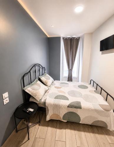 a bedroom with a bed and a window at Hôtel Faculté in Marseille