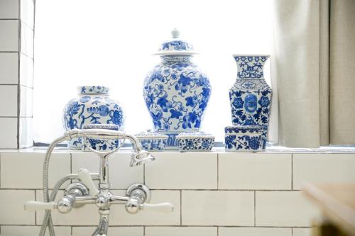 three blue and white vases sitting on a shelf at Les Nuits in Antwerp