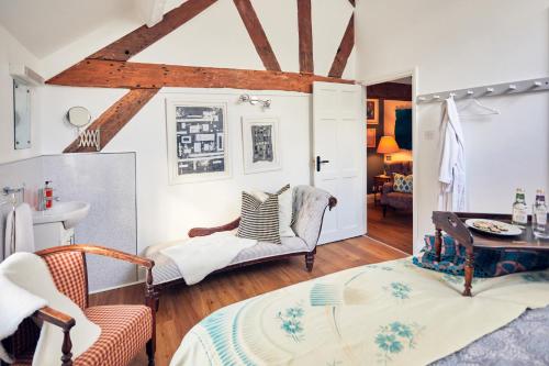 a room with a bed and a table and chairs at Apple Bough Cottage in Hereford