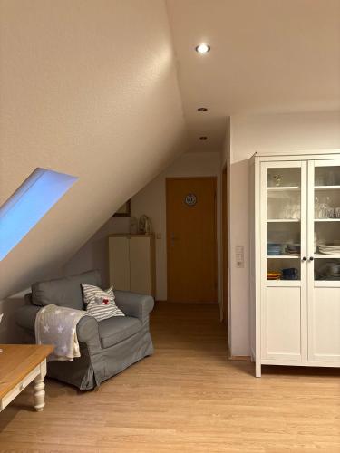 a living room with a couch and a staircase at Ferienwohnung Seestern-Ranch in Niederlangen