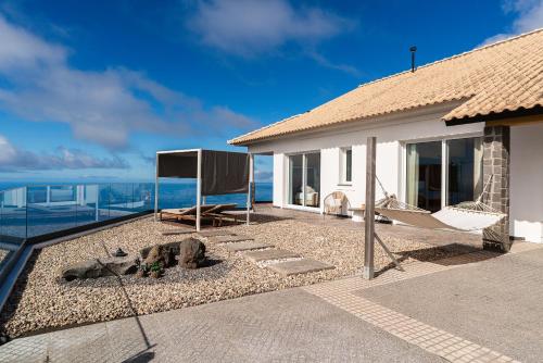 a house with a view of the ocean at Villa Sea Colors by An Island Apart in Arco da Calheta