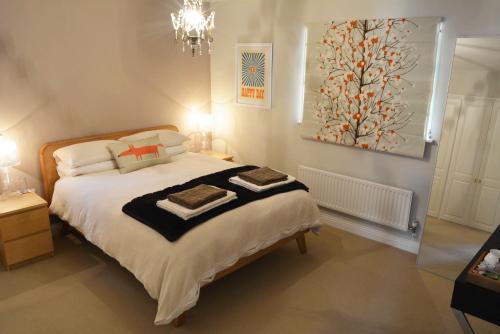 a bedroom with a large bed and a painting on the wall at Walton Crescent in Winford