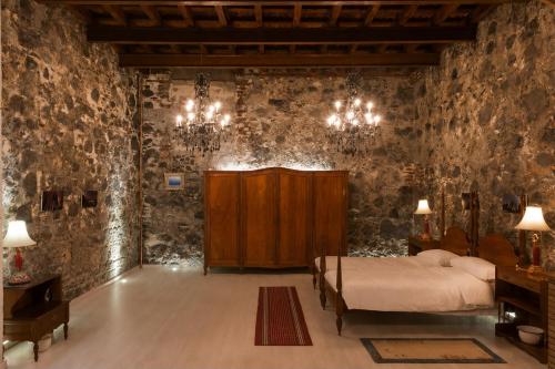 a bedroom with a bed in a room with stone walls at Casa Emblematica Amelia in Santa Cruz de la Palma