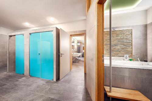 a bathroom with a glass door and a tub at Kneippkurhaus St Josef in Bad Wörishofen