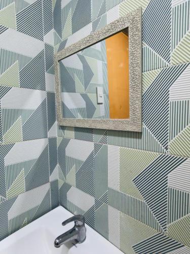 a bathroom with a mirror and a sink at Beachside Room with Bathroom San Juan ELYU in San Juan