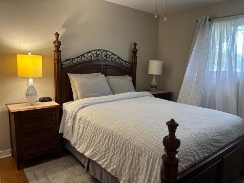 a bedroom with a large bed and a window at Three Pines Private Bedroom Suite in Moncton