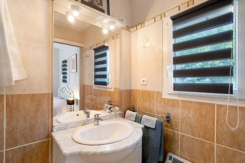 a bathroom with a sink and a tub and a window at Studio Montayral in Montayral