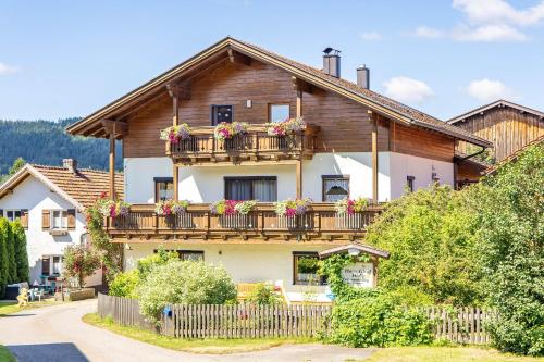 a house with a balcony with flowers on it at Hans-Girgl-Hof in Langdorf