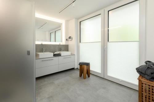 a bathroom with a sink and a mirror at Wohnung 14 Am Januspark in Juist