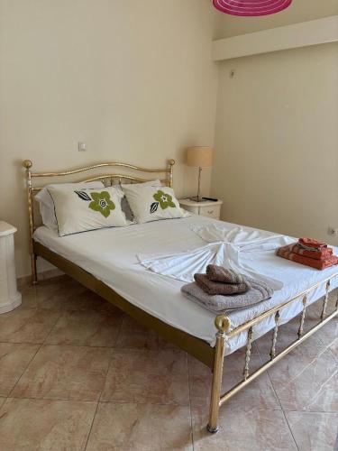 a bed with white sheets and pillows in a bedroom at Garbo Appartments in Karistos