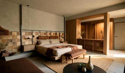 a bedroom with a bed and a couch and a table at Ella Elyra - Adults Only in Pelekas