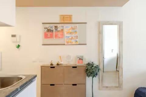a kitchen with a cabinet and a sink and a mirror at Studio Home Madrid in San Sebastián de los Reyes
