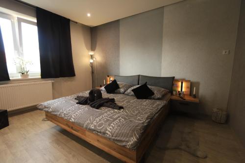 a bedroom with a bed with a dog on it at Apartmán Elarys in Nezdenice