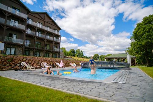 a group of people in the pool at a hotel at Willa Zieleniec - apartamenty z Ogrodem SPA in Duszniki Zdrój
