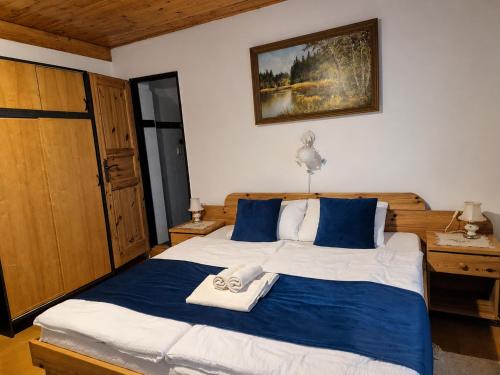 a bedroom with a large bed with towels on it at Penzión Daria in Batizovce